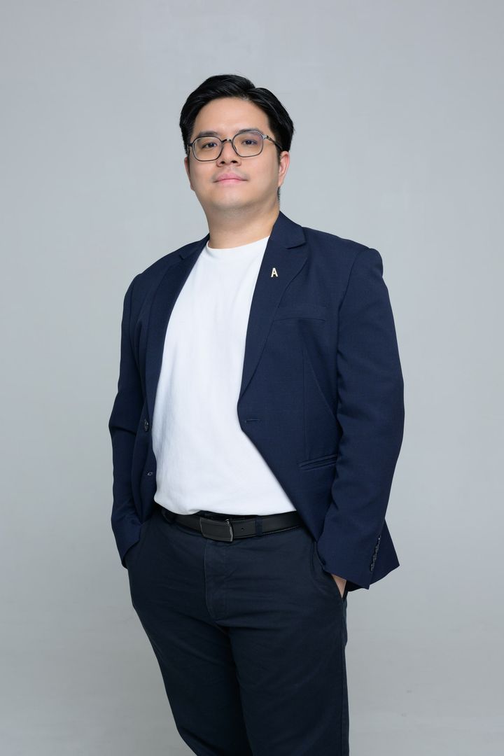 Jun Xian in a navy blazer and white tee